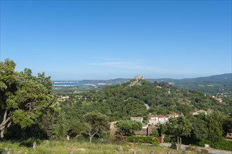 Landscape with the castle of Grimaud, in the background the Gulf of Sant-Tropez and the hills of