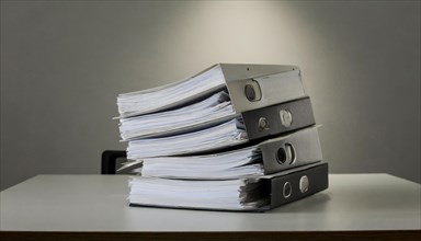 Stacks of black folders with many pages on a desk, symbolism bureaucracy, AI generated, AI