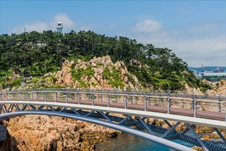 A bridge leading to a lighthouse on a rocky outcrop by the sea, in Ulsan, South Korea, Asia