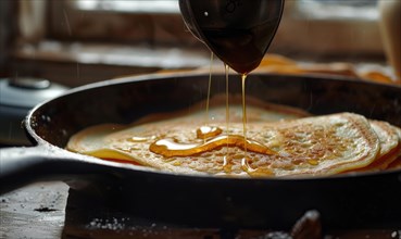 Golden brown pancakes in a cast iron pan being drizzled with sticky syrup AI generated