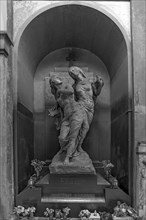 Sculptures on a grave in a niche in the Monumental Cemetery, Cimitero monumentale di Staglieno),