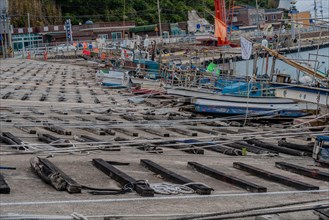 Array of ropes and mooring lines in a busy fishing boat dry dock on a grey day, in Ulsan, South