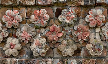 Aged flower carvings on decorative tiles spread across a brick wall AI generated