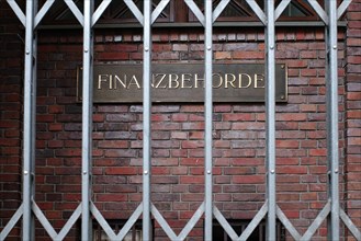 Sign with inscription 'Finanzbehoerde hinter Gittern', Hanseatic City of Hamburg, Hamburg, Germany,