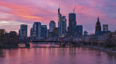 The Frankfurt skyline with office towers behind the Main at sunset, on the right the Kaiserdom,