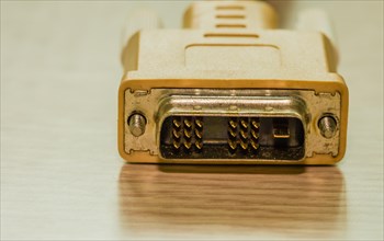 Close-up of a gold-colored DVI connector for computer cabling, in South Korea