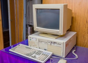 Old computer with both 3.5 and 5 inch disk drive complete with crt monitor and keyboard in