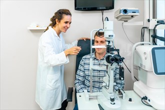 Horizontal photo of a man sitting doing a routine checkup in an ophthalmologist