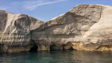 Caves in the white rocks on the coast near Sarakinikoer, Milos, Cyclades, Greece, Europe