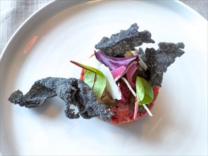 Bull Tartare with Black Charcoal Garlic and Tropea Onion with Parmesan Cheese in Switzerland