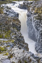 Rushing stream plunges into a narrow gorge, Fjallabak Nature Reserve, Sudurland, Iceland, Europe