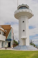A white lighthouse with a circular balcony against a blue sky, in Ulsan, South Korea, Asia