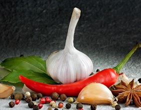 Fresh garlic arranged with red chilli, colourful peppercorns and green herbs, AI generated, AI