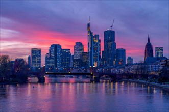 The Frankfurt skyline with office towers behind the Main at sunset, on the right the Kaiserdom,