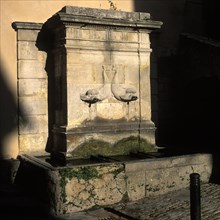 Dolphin fountain in Bonnieux, Luberon, Vaucluse, Provence, France, Europe
