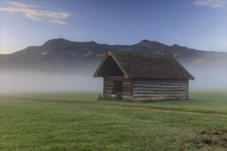 Small wooden hut, morning mood over mountains, fog, spring, Loisach-Lake Kochel-Moor, Bavaria,