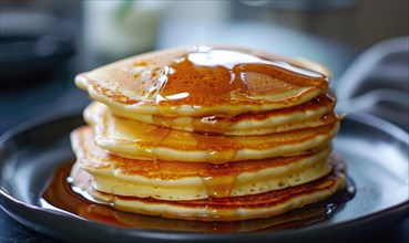 Syrup gleaming on a stack of pancakes, with focus on the top pancake AI generated