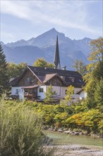 Loisach with houses, old parish church St. Martin, Wetterstein mountains with alpine seats,