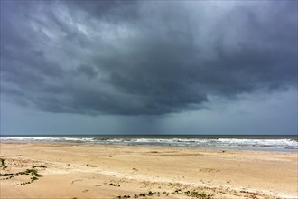 Dark rain clouds over the sea at Sargi beach in Serra Grande on the coast of Bahia, Bahia, Brazil,