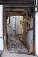 Narrow alley with cobblestones in the historic old town, Schlossgasse, passage through a