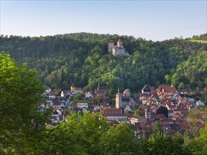 View of the town of Treffurt in the Werra Valley and Normannstein Castle in the evening light,