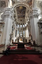 St Stephen's Cathedral, Passau, Church interior with view of the altar, permeated by rays of light