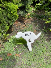 Sign in front garden in the form of a dog pooping dog pooing dog pooing dog pooing dog pooing dog