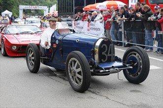 A historic blauer racing car at the starting line with driver in helmet, SOLITUDE REVIVAL 2011,