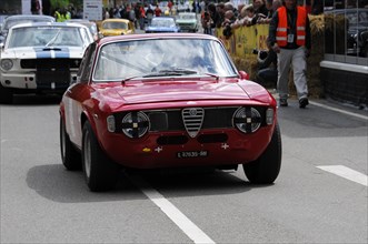 A red Alfa Romeo as a racing car on a track surrounded by spectators, SOLITUDE REVIVAL 2011,
