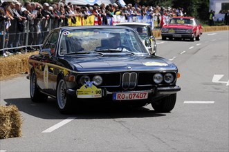 A black BMW vintage racing car in front of spectators at a classic car race, SOLITUDE REVIVAL 2011,