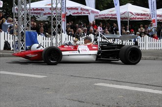 A formula racing car on a street race track with spectators in the background, SOLITUDE REVIVAL