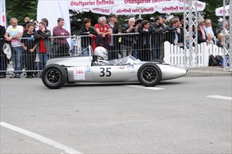 A white formula racing car with the number 35 in front of spectators in the racing area, SOLITUDE