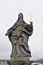 Statue of Saint Kilian on the old Main bridge, statue of a bishop or saint with a sword, on a