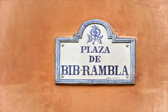 Granada, A white and blue street sign of the Plaza de Bib-Rambla with arabesque decorations,