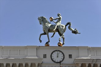 Granada, Statue of a horseman on horseback in front of a clear blue sky on the roof of a building,
