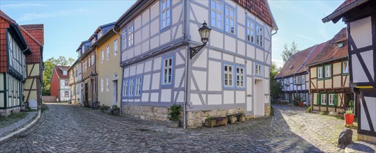 Narrow alley with half-timbered houses and cobblestones in the historic old town, Halberstadt,