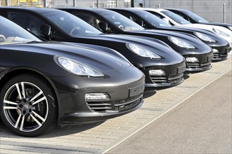 A row of black Porsche cars parked in a car park, Schwaebisch Gmuend, Baden-Wuerttemberg, Germany,
