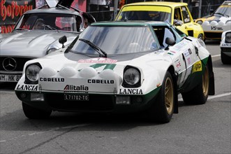 A white and green Lancia Stratos with the number 419 in rally livery at a race, SOLITUDE REVIVAL