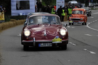A small red car drives on a rally, SOLITUDE REVIVAL 2011, Stuttgart, Baden-Wuerttemberg, Germany,