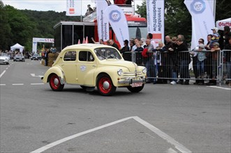 A small yellow and red vintage car takes part in a historic car race, SOLITUDE REVIVAL 2011,