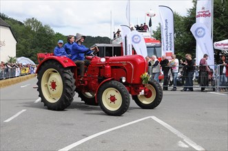 Porsche Diesel Tractors, A historic red tractor is proudly driven in a summer parade, SOLITUDE