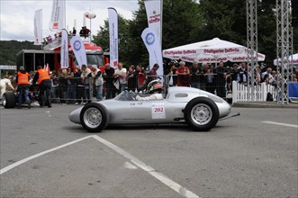Silver historic racing car on a race track with spectators on the sidelines, SOLITUDE REVIVAL 2011,