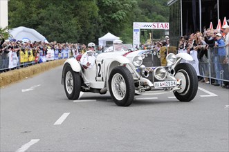 Mercedes-Benz SSK, built in 1928, A white vintage racing car with the number 12 on a race track,