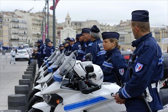 Marseille city hall, motorbike police stand next to their motorbikes and watch over security,