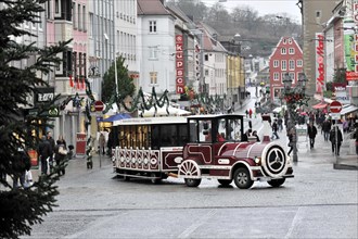 Wuerzburg, tourist train travelling through the pedestrian zone of a European city with Christmas