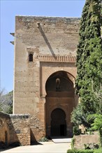 Alhambra, Granada, Andalusia, Old gate with a tree on the side and a clear shadow play, Granada,