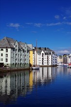 Houses reflected in the calm waters of a harbour, Art Nouveau, Kaiser Wilhelm II, Alesund, Norway,