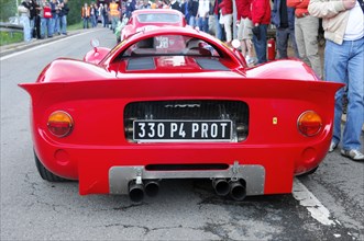 Rear view of a red super sports car on a race track with spectators, SOLITUDE REVIVAL 2011,