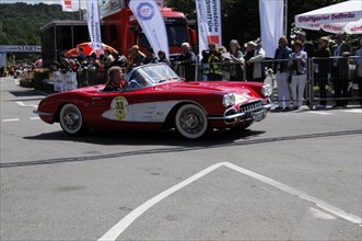 A red Chevrolet convertible classic at a classic car race watched by spectators, SOLITUDE REVIVAL