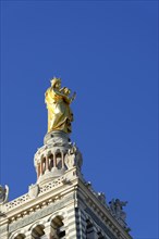 Church of Notre-Dame de la Garde, Marseille, Golden religious statue on a cathedral in front of a
